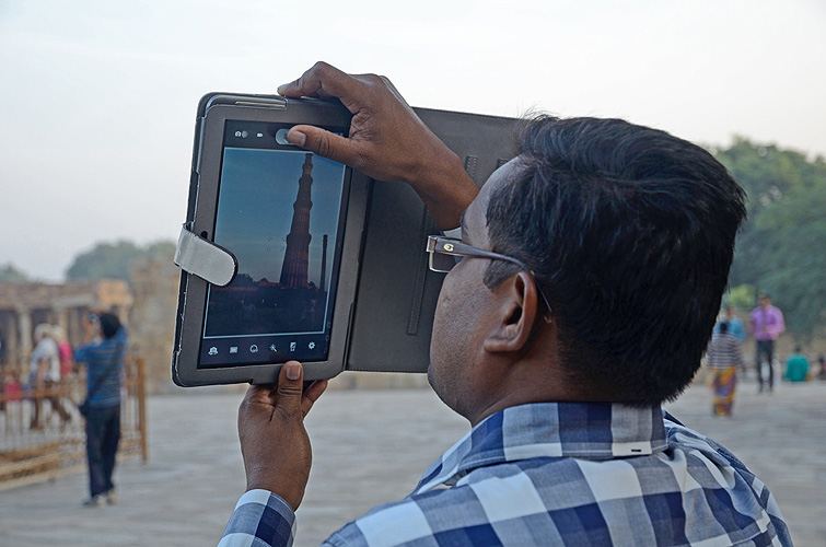 Tourist fotografiert das Qutub Minar-Minarett in Delhi - Touristen 04